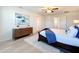Spacious bedroom featuring luxury vinyl plank flooring, a ceiling fan, and a dresser at 3279 Landing Vw, Tavares, FL 32778