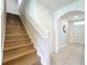 Hallway with wooden staircase featuring wooden steps and white painted risers and railing at 3279 Landing Vw, Tavares, FL 32778