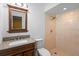 Modern bathroom featuring a tiled walk-in shower, vanity, and contemporary mirror at 333 Crystal Cir, Oviedo, FL 32765