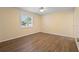 Bright bedroom with updated flooring, neutral paint, and natural light from the window at 333 Crystal Cir, Oviedo, FL 32765