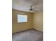 A bright bedroom featuring carpet floors, a ceiling fan, and a window overlooking the backyard at 333 Crystal Cir, Oviedo, FL 32765