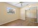 Bedroom with updated flooring, ceiling fan, and a mirrored closet at 333 Crystal Cir, Oviedo, FL 32765