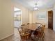 Inviting dining area with tile flooring and wooden furniture, adjacent to a well-lit kitchen at 333 Crystal Cir, Oviedo, FL 32765