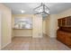 Dining area featuring tile flooring, modern light fixture, and view into updated kitchen at 333 Crystal Cir, Oviedo, FL 32765