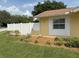 A close up of the side of a single-story home with a white picket fence and some flower beds at 333 Crystal Cir, Oviedo, FL 32765