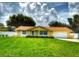 Charming single-story home featuring a lush green lawn and a welcoming yellow exterior at 333 Crystal Cir, Oviedo, FL 32765