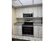 Updated kitchen features stainless steel appliances, granite countertops, and white cabinets at 333 Crystal Cir, Oviedo, FL 32765