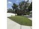 A wide lawn on the side of a street and close to a house protected by a white picket fence at 333 Crystal Cir, Oviedo, FL 32765