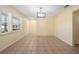 Open-concept living room with tile flooring, neutral walls, plantation shutters, and modern lighting at 333 Crystal Cir, Oviedo, FL 32765