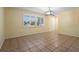 Large living room with plantation shutters, tile flooring, and a modern light fixture at 333 Crystal Cir, Oviedo, FL 32765