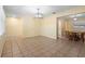 Bright living room leading into dining area, featuring tile floors and modern lighting fixtures at 333 Crystal Cir, Oviedo, FL 32765
