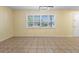Open concept living room featuring tile floors, neutral walls, and a modern lighting fixture at 333 Crystal Cir, Oviedo, FL 32765