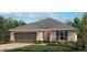 Charming single-story home featuring a two-car garage and well-manicured landscaping at 3381 Sanctuary Dr, Clermont, FL 34714