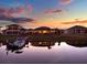 Lovely lakeside homes with docks provide peaceful sunset views from the backyard at 3707 Paradiso Cir, Kissimmee, FL 34746
