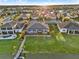 Aerial view displays a home with a screened-in patio, backyard, and private dock, set against a serene waterfront backdrop at 3707 Paradiso Cir, Kissimmee, FL 34746