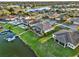 Aerial view of a waterfront community with serene water views, lush landscaping, and private boat docks at 3707 Paradiso Cir, Kissimmee, FL 34746