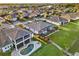 Aerial view features a home with a screened-in patio, pool, and a waterfront backyard with private dock access at 3707 Paradiso Cir, Kissimmee, FL 34746