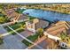 Aerial perspective of waterfront houses features beautiful landscaping and brick driveways, highlighting the tranquil community setting at 3707 Paradiso Cir, Kissimmee, FL 34746