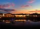 Waterfront homes boast beautiful views and private docks at sunset at 3707 Paradiso Cir, Kissimmee, FL 34746