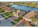 Aerial view captures stunning waterfront homes with well-kept lawns, brick driveways, and peaceful water access at 3707 Paradiso Cir, Kissimmee, FL 34746