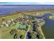 Aerial view showcasing community amenities including tennis courts and waterfront access at 3707 Paradiso Cir, Kissimmee, FL 34746
