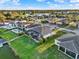 Aerial scene features a home with a pool, screened patio, and private dock access, overlooking tranquil waterfront scenery at 3707 Paradiso Cir, Kissimmee, FL 34746
