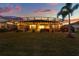 Beautiful backyard and patio with screened in pool at dusk at 3707 Paradiso Cir, Kissimmee, FL 34746