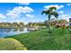 Beautiful backyard with a lush lawn leading to a private dock on the lake at 3707 Paradiso Cir, Kissimmee, FL 34746