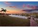 Lakeside backyard with lush lawn and a private dock with boats at 3707 Paradiso Cir, Kissimmee, FL 34746