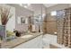 Well-lit bathroom with white cabinets, decorative shower curtain, and granite countertops at 3707 Paradiso Cir, Kissimmee, FL 34746