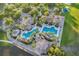 Aerial view of a resort-style pool area with palm trees, lounge chairs, and a splash pad for  at 3707 Paradiso Cir, Kissimmee, FL 34746