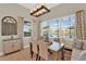 Bright dining room featuring large windows with lake views and stylish furnishings at 3707 Paradiso Cir, Kissimmee, FL 34746