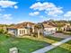 A beautifully landscaped single story home has a three car garage and lush green lawn at 3707 Paradiso Cir, Kissimmee, FL 34746