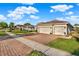 Street view of a single story home with a three car garage and manicured lawn at 3707 Paradiso Cir, Kissimmee, FL 34746