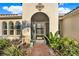 Front door entrance featuring beautiful tile work and lush landscaping at 3707 Paradiso Cir, Kissimmee, FL 34746
