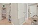 Hallway with tiled floors and neutral paint showcasing storage and access to other rooms at 3707 Paradiso Cir, Kissimmee, FL 34746