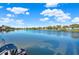 Scenic view of the peaceful lake with lush green surroundings and clear blue skies at 3707 Paradiso Cir, Kissimmee, FL 34746
