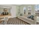 Open living area with neutral paint, arched windows, and adjoining dining space at 3707 Paradiso Cir, Kissimmee, FL 34746