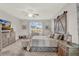 Spacious main bedroom featuring a decorative headboard, ceiling fan, and seating area at 3707 Paradiso Cir, Kissimmee, FL 34746