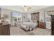 Comfortable main bedroom featuring a decorative headboard, ceiling fan, and lots of natural light at 3707 Paradiso Cir, Kissimmee, FL 34746