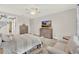Bright main bedroom with two dressers, ceiling fan, neutral colors, and an ensuite bathroom through the door at 3707 Paradiso Cir, Kissimmee, FL 34746