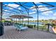 The covered outdoor patio features lounge chairs and shade with peaceful lake views for ultimate relaxation at 3707 Paradiso Cir, Kissimmee, FL 34746