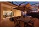 Covered patio featuring outdoor seating, dining area, spa, and seamless access to indoor living spaces at 3707 Paradiso Cir, Kissimmee, FL 34746