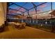 Enjoy the evening on this screened-in patio with a spa, dining set, and beautiful water views at 3707 Paradiso Cir, Kissimmee, FL 34746