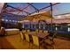 Relaxing screened-in patio with dining set, spa, and beautiful water view at sunset at 3707 Paradiso Cir, Kissimmee, FL 34746