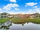 Aerial view of homes, docks, and serene lake with lush green lawns at 3707 Paradiso Cir, Kissimmee, FL 34746