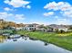 Beautiful waterfront homes feature lush lawns, private docks, and serene water views under a partly cloudy sky at 3707 Paradiso Cir, Kissimmee, FL 34746