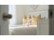 Sunlit bedroom featuring a white bed, soft pillows, and decorative fish art creates a serene atmosphere at 3739 Bluethread Way, Poinciana, FL 34759