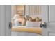 Cozy bedroom with neutral bedding, decorative pillows, side table, and lamp offers a relaxing retreat at 3739 Bluethread Way, Poinciana, FL 34759