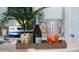 Kitchen counter with tropical plants, LaMarca Prosecco, drinkware, and orange juice for a vibrant touch at 3739 Bluethread Way, Poinciana, FL 34759